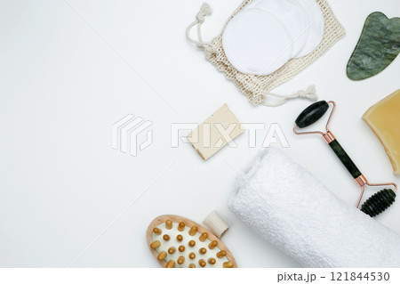Eco-friendly beauty products: massage brush, marble roller, towel, reusable cotton pads, sustainable self-care concept 121844530