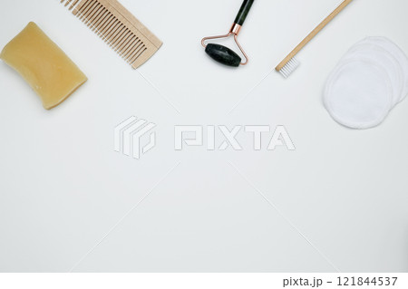 Eco-friendly beauty essentials, including bamboo toothbrush, marble face roller, embodying a sustainable self-care concept Eco-friendly beauty essentials, including bamboo toothbrush, marble face roller, embodying a sustainable self-care concept 121844537