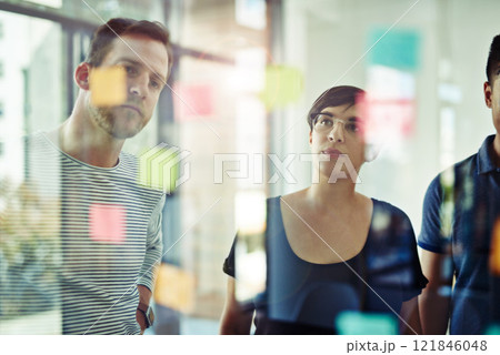 Manager, leader or boss talking and planning in a workshop, seminar or presentation with sticky notes in a boardroom. Business woman discussing and brainstorming with her colleagues and coworkers 121846048