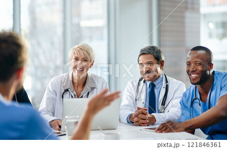 Unity, teamwork and happy health care workers having a meeting in a conference room. Diverse doctors discussing modern treatments and innovation, brainstorming to find a cure for sickness and disease Unity, teamwork and happy health care workers having a meeting in a conference room. Diverse doctors discussing modern treatments and innovation, brainstorming to find a cure for sickness and disease 121846361