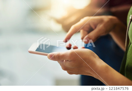 Closeup of hands of a corporate business person typing on a phone while standing in an office. Top view of a professional scrolling through social media, checking and reading texts and sending emails Closeup of hands of a corporate business person typing on a phone while standing in an office. Top view of a professional scrolling through social media, checking and reading texts and sending emails 121847576