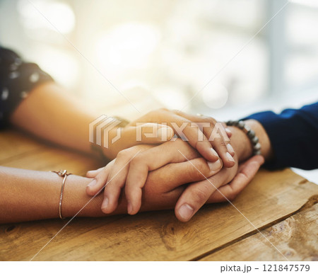 Holding hands showing care, love and support between friends, couple or family. People comforting, giving affection and embracing friendship with a hand gesture and touch during a difficult time Holding hands showing care, love and support between friends, couple or family. People comforting, giving affection and embracing friendship with a hand gesture and touch during a difficult time 121847579