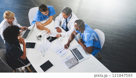 Team of medical workers sitting and meeting with laptops around table. Doctors and staff discussing papers and test results. Healthcare experts handling daily tasks and duties Team of medical workers sitting and meeting with laptops around table. Doctors and staff discussing papers and test results. Healthcare experts handling daily tasks and duties 121847593