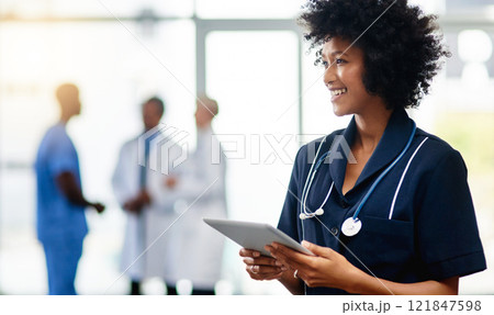 Nurse, medical professional and healthcare worker with tablet and afro feeling happy after checking positive test result reports on technology. Smiling and friendly doctor ready to help in hospital Nurse, medical professional and healthcare worker with tablet and afro feeling happy after checking positive test result reports on technology. Smiling and friendly doctor ready to help in hospital 121847598