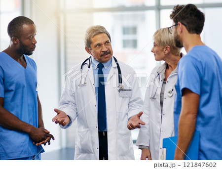 Doctors talk, brainstorm and plan together to collaborate and discuss medical procedures in a hospital. Health professional colleagues consult and working together in a meeting while sharing ideas Doctors talk, brainstorm and plan together to collaborate and discuss medical procedures in a hospital. Health professional colleagues consult and working together in a meeting while sharing ideas 121847602