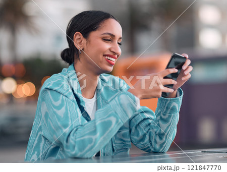 Happy woman texting on a phone, browsing social media or chatting on an instant, trendy and online chat app. Single female looking confident, reading a message on a dating website 121847770