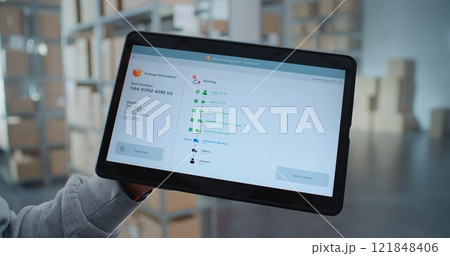 Tablet Screen Shows Delivery Tracking App Interface to Check Parcel Routing to Customer 121848406