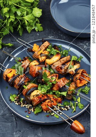 Tasty cooked sweet potato on skewers. Tasty cooked sweet potato on skewers. 121848457