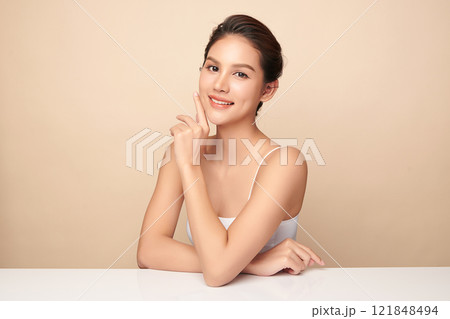 Beautiful young asian woman with clean fresh skin on beige background, Face care, Facial treatment, Cosmetology, beauty and spa, Asian women portrait. Beautiful young asian woman with clean fresh skin on beige background, Face care, Facial treatment, Cosmetology, beauty and spa, Asian women portrait. 121848494