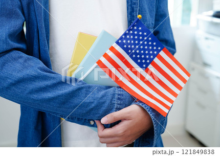 Learn English language, Asian teenage student hold book with flag in course at school. 121849838