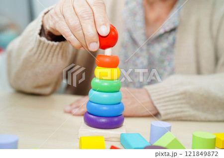 Asian elderly woman playing game. 121849872