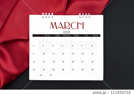 March 2025 Monthly desk calendar with red silk on black leather background. March 2025 Monthly desk calendar with red silk on black leather background. 121850758
