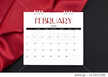 February 2025 Monthly desk calendar with red silk on black leather background. February 2025 Monthly desk calendar with red silk on black leather background. 121851106