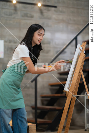 Lifestyle, people artist painting on canvas in the home studio. 121851216