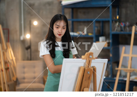 Lifestyle, people artist painting on canvas in the home studio. 121851217