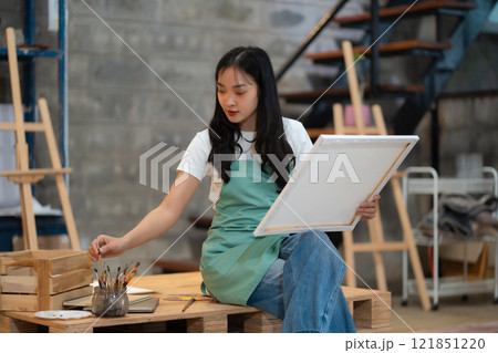 Lifestyle, people artist painting on canvas in the home studio. 121851220