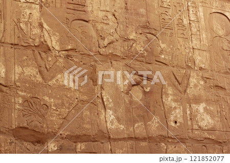 Part of the ancient wall at Karnak Temple in Luxor, Egypt. Karnak Temple in Luxor (Egypt) is a massive ancient temple complex. It was dedicated to the god Amun-Ra and his wife Mut 121852077