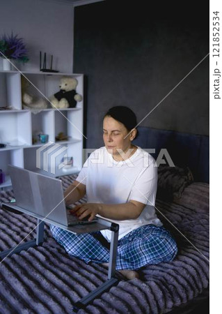 a senior woman working from home on laptop a senior woman working from home on laptop 121852534