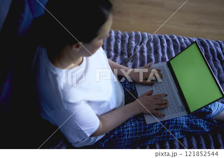 a senior woman working from home on laptop, green screen, chromakey 121852544
