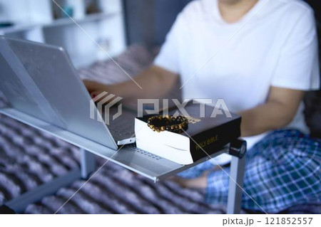 a senior woman attends online church, video conference with priest a senior woman attends online church, video conference with priest 121852557