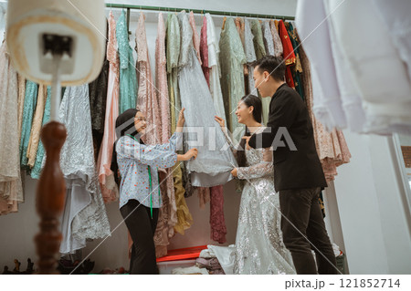 Experience a Bridal Fitting Session featuring Elegant Gowns in a Fashion Studio Experience a Bridal Fitting Session featuring Elegant Gowns in a Fashion Studio 121852714