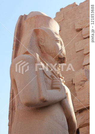 Partly damaged pharaoh statue in Luxor, Egypt. Ancient travel destination in North Africa. Partly damaged pharaoh statue in Luxor, Egypt. Ancient travel destination in North Africa. 121853688