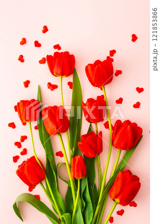 Red tulips and hearts on pink background Red tulips and hearts on pink background 121853866