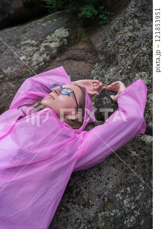Woman in Pink Raincoat Enjoying Nature 121853951