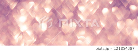 Romantic heart-shaped light bokeh background with soft pink and warm golden tones 121854387
