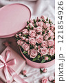 Romantic pink roses in a gift box for Valentines Day. Concept of love, affection, and celebrating special moments with heartfelt gifts. Valentines day celebration background.. 121854926