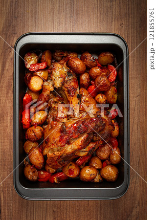 Pork knuckle, baked with vegetables, new potatoes , on a baking sheet, homemade, no people, Pork knuckle, baked with vegetables, new potatoes , on a baking sheet, homemade, no people, 121855761
