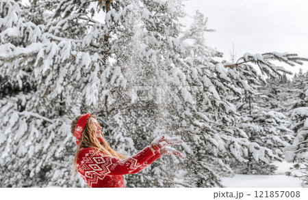 Women in Sweater Playing with Snow in Winter Forest 121857008