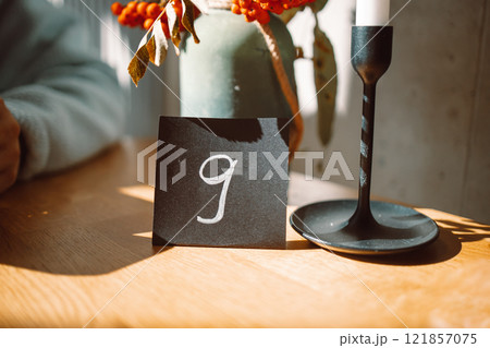 white number nine sign of a black stand for ordering food placing on a wood table in a cafe white number nine sign of a black stand for ordering food placing on a wood table in a cafe 121857075