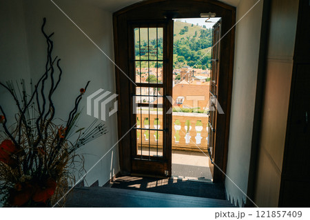 Inviting Open Door with Scenic View and Sunlit Interior, creating a warm 121857409