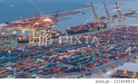 Seaport and loading docks at the port with cranes and multi-colored cargo containers day to night timelapse Seaport and loading docks at the port with cranes and multi-colored cargo containers day to night timelapse 121859813