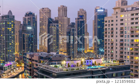 Aerial view of Dubai Marina after sunset from a vantage point day to night timelapse. Aerial view of Dubai Marina after sunset from a vantage point day to night timelapse. 121859882