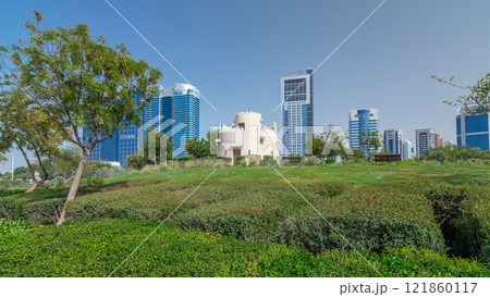 Corniche boulevard beach park along the coastline in Abu Dhabi timelapse hyperlapse with skyscrapers on background. Corniche boulevard beach park along the coastline in Abu Dhabi timelapse hyperlapse with skyscrapers on background. 121860117