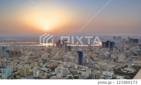 Sunrise with cityscape of Ajman from rooftop aerial timelapse. 121860173