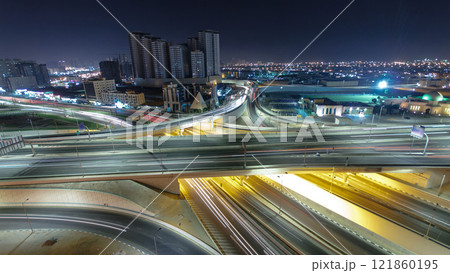 Traffic on a big road junction in Ajman aerial view from rooftop at night timelapse. Traffic on a big road junction in Ajman aerial view from rooftop at night timelapse. 121860195