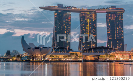 Marina Bay Sands Hotel dominates the skyline at Marina Bay in Singapore night to day timelapse. Marina Bay Sands Hotel dominates the skyline at Marina Bay in Singapore night to day timelapse. 121860259