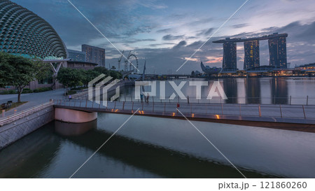 Skyline in Marina Bay with Esplanade Theaters on the Bay and Esplanade footbridge night to day timelapse in Singapore. 121860260