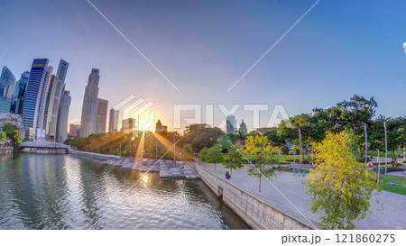 Sunset over Singapore skyscrapers skyline with white Anderson Bridge near esplanade park timelapse. Sunset over Singapore skyscrapers skyline with white Anderson Bridge near esplanade park timelapse. 121860275