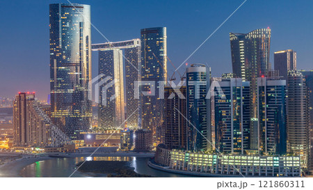Buildings on Al Reem island in Abu Dhabi day to night timelapse from above. 121860311