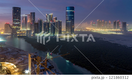 Buildings on Al Reem island in Abu Dhabi timelapse from above. 121860312