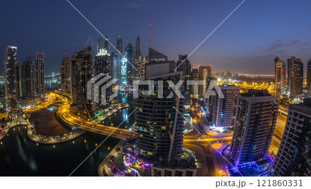 Aerial view of Dubai Marina residential and office skyscrapers with waterfront night to day timelapse 121860331