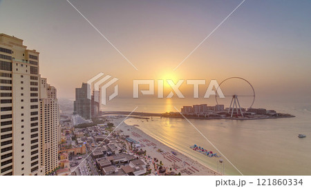 Sunset waterfront overview Jumeirah Beach Residence JBR skyline aerial timelapse with yacht and boats 121860334