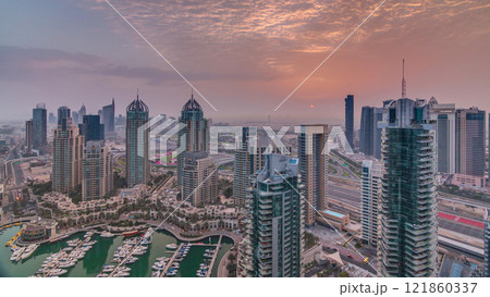 Aerial top view of sunrise in Dubai Marina timelapse. Modern towers and traffic on the road 121860337