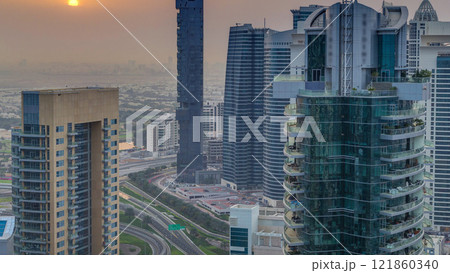 Aerial top view of sunrise in Dubai Marina timelapse. Modern towers and traffic on the road Aerial top view of sunrise in Dubai Marina timelapse. Modern towers and traffic on the road 121860340