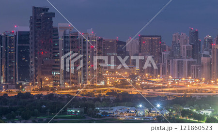 Jumeirah lake towers and Dubai marina skyscrapers and golf course night to day timelapse, Dubai, United Arab Emirates Jumeirah lake towers and Dubai marina skyscrapers and golf course night to day timelapse, Dubai, United Arab Emirates 121860523