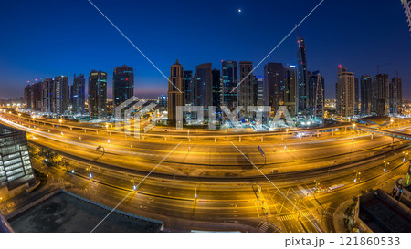 Aerial view of Jumeirah lakes towers skyscrapers night to day timelapse with traffic on sheikh zayed road. 121860533